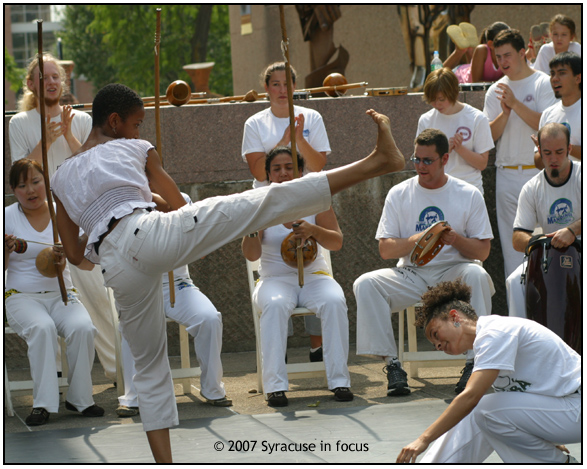 Sept. 9--Jogo de Capoeira--Keisha Clarke (left) of Rochester performs with Syracuse dance teacher Odetta Norton yesterday during a Capoeira demonstration at the Everson Museum. 