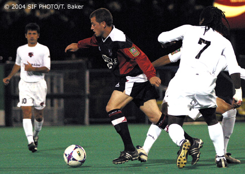 June 12 (SYRACUSE) Salty Dogs Midfielder Chris Dore (center), one of the A-Leagues top scorers this season, breaks away from the defense during the second half of the game last night against the Atlanta Silverbacks. Dore's spirited play, and his second half goal were the lone bright spots in another loss for the Salty Dogs, who dropped to 3-4-2.  