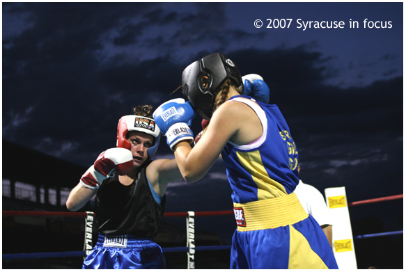 August 18--Friday Night Fights--Nicole Yandin (left) and Caroline Buerkle, both of Syracuse, exchange blows during a fight card P&C Stadium that was delayed for over an hour by a rain shower.