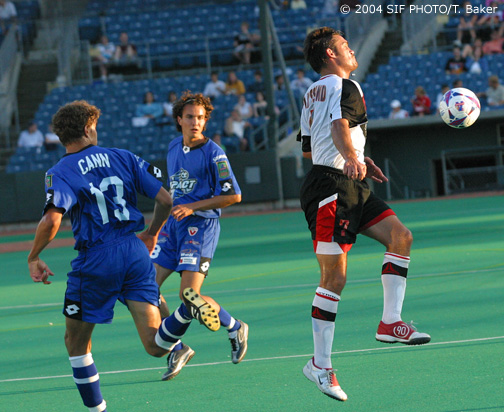 Syracuse Salty Dogs Defender Lars Lyssand (number 7) plays a ball off his chest to stop a offensive surge by the Montreal Impact. This photo was taken during a mid-July contest where Syracuse beat Montreal twice.