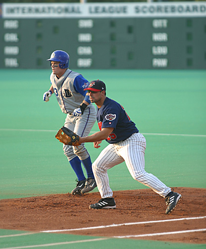 (Pictured) Shawn Fagan holds a runner in the early innings of a June game with Durham.