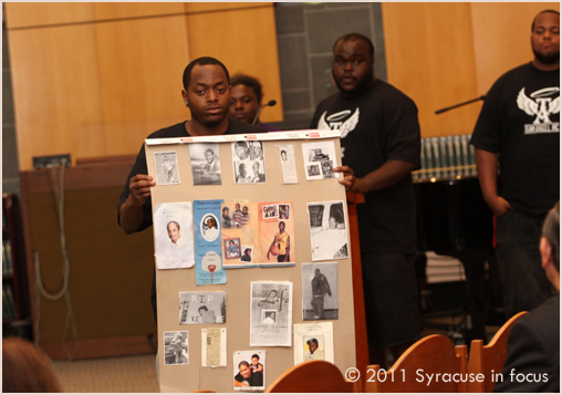 Ed Mitchell, Jr. shows a memorial poster made by teens in the Team A.N.G.E.L. Program