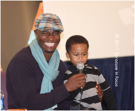 Taye Diggs gets some help during a song peformance with Shane Evans at the Greater Evangelical COGIC