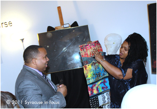Griot Vanessa Johnson presents George Kilpatrick, Jr. with a quilt