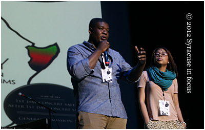 Abdul Karim Abdullah, a 2010 SU grad, and Cassandra, members of Be Great Foundation, address the students and crowd during the Save the Horn concert.