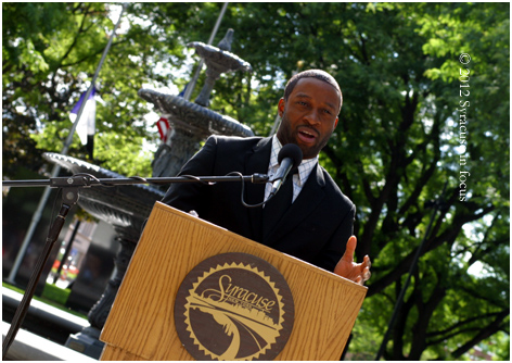 Bj Adigun, environmental advocate for Onondaga County, speaks about at the dedication environmental benefits of green infrastructure in cities