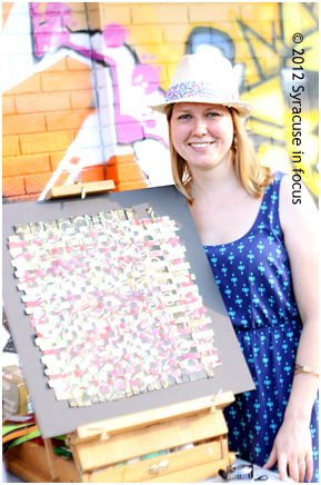 Artist Emily Bender participated in the Art People Open Air Show in the S.A.L.T. District on Saturday. She is pictured here with her ribbon/paint creation she calls "Bigger Fish to Fry."