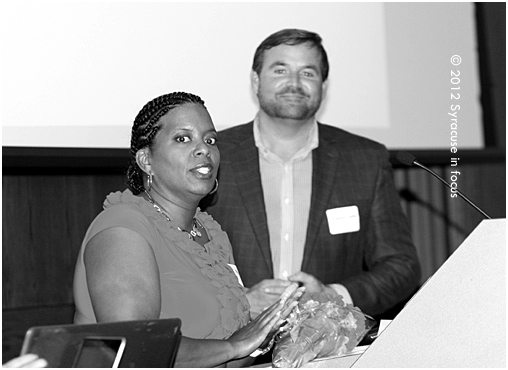 Vision Center Program Director Gina Rivers along with Rev. John Carter salute graduates of the 2012 Synergy Program during a ceremony at Upstate Medical Center on Friday.