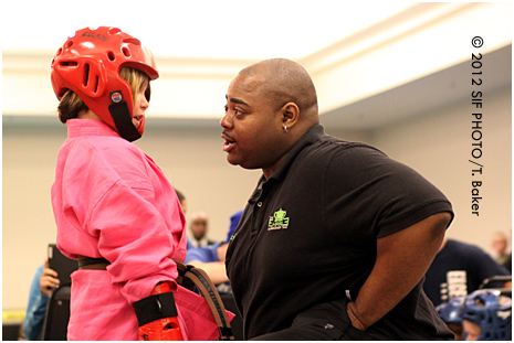 Head judge Ritchie Everage gives a pep talk to a competitor at the New York State Martial Arts Showcase on Friday night.