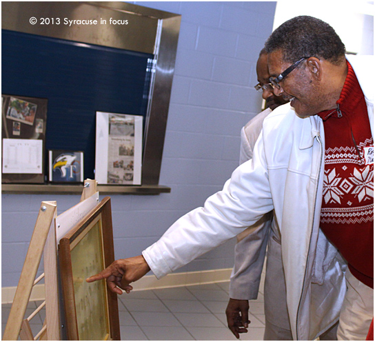 Central Tech alum and basketball legend Roy Neal points out members of a historic champsionship team at Central Tech from a vintage photo.