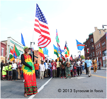 Habiba Boru gets ready at the 500 block N. Salina Street on World Refugee Day. She lead the Refugee parade to downtown Syracuse.