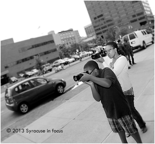 Journalist/Photographer LaVergne Harden and her son working in downtown Syracuse.