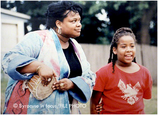 Griot Vanessa Johnson (left) coaxing a student performance during an open-air performance on the southside about 10 years ago.