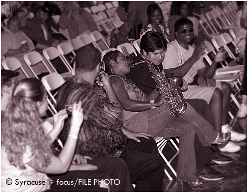 Pamela Williams serenades Syracuse's Al Cutri with her sax during the 2008 Northeast Jazz & Wine Festival (Clinton Square).