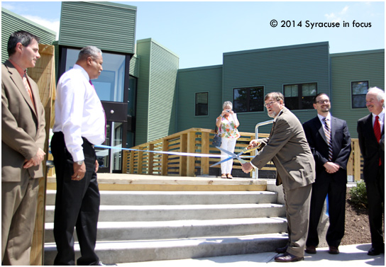 Su Casa es me llamo: Robert Van Keuren cuts the ribbon on the East Genesee housing complex that bears his name last week.