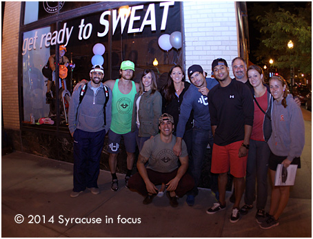 The Urban CrossFit Posse poses in front of their window for the Live Models Landmark project on Tuesday night.