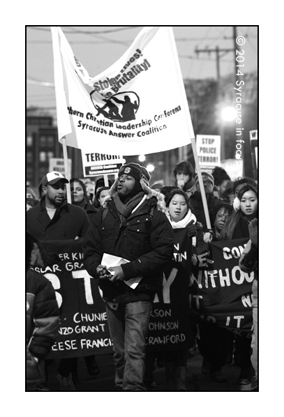 Jones rallies the marchers as they head toward Almond Street (under Route I81)