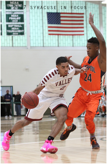 Corcoran's Jahaad Henry drove past Liverpool's Najheir Johnson for 2 of his 18 points in the third quarter, but Warriors wore down the Cougars and won 74-57.