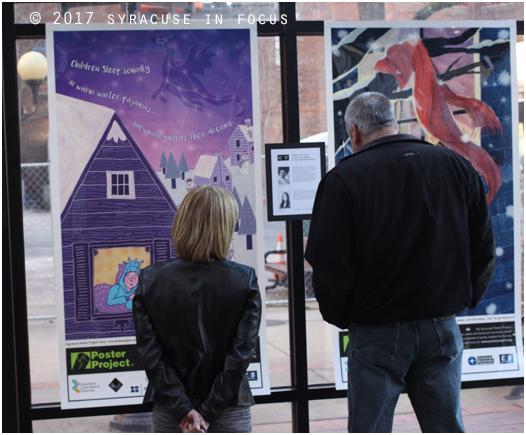 Admirers of posters in the City Hall Commons Atrium.