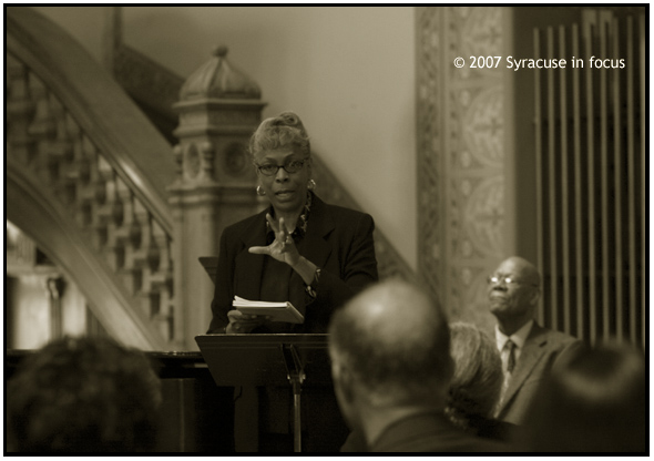 March 23-Musicology--Retired Syracuse educator Mary Virginia Willie Gauthier says spirituals and gospel music are not the same and are actually separate and unequal, She lectured at Syracuse University's Crouse College Setnor Auditorium during a workshop that focused on Negro spirituals in America. She was joined in the lecture and in performance of songs by Dr. Harlan London (seated rear).