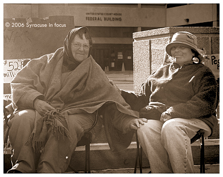 (April 15)  Peace activists Elana Levy (right) and Kathleen Rumpf continued their week-peace vigil outside the Federal Building in downtown Syracuse this weekend. 